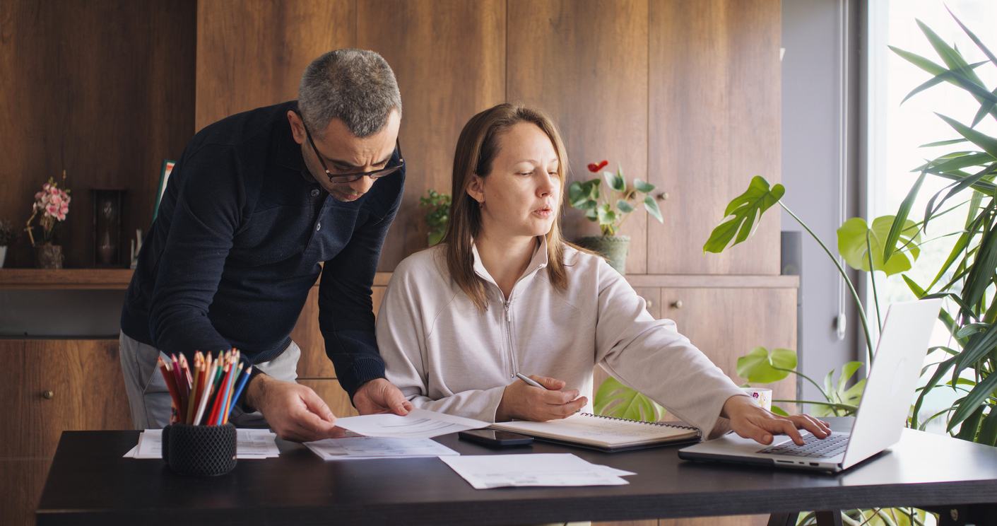 Couple reviewing balance sheet to see if it is reliable