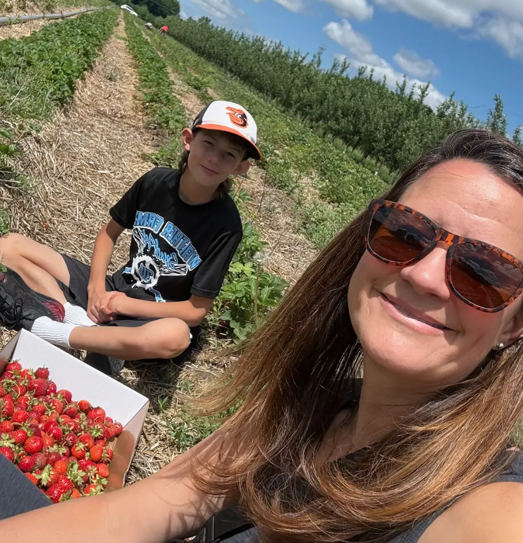 Kelly Martin with her son picking strawberries
